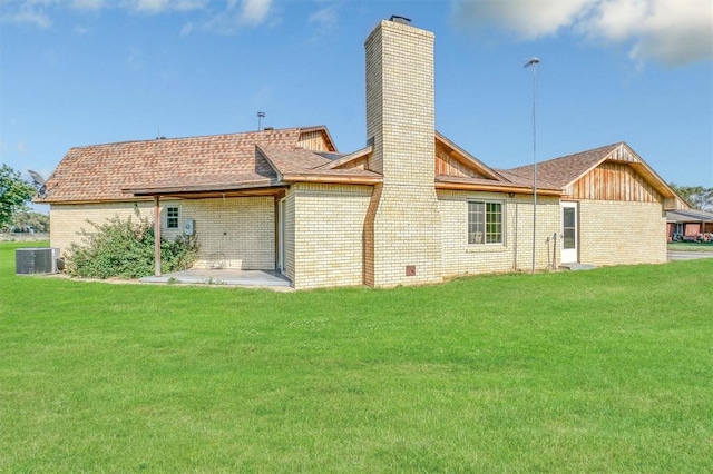 rear view of house featuring a lawn, a patio area, and central air condition unit