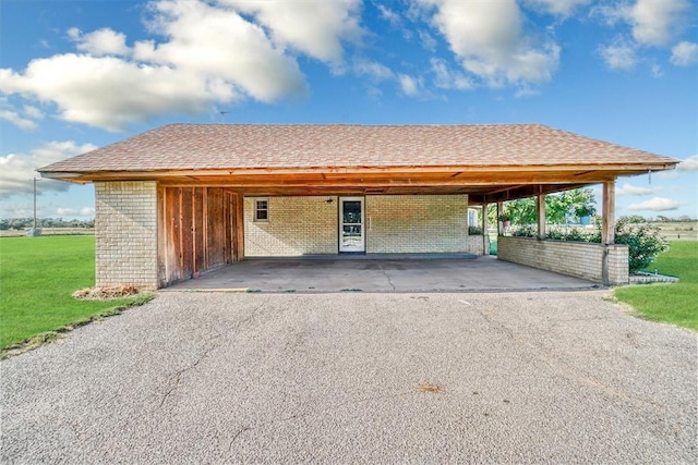 garage featuring a yard and a carport