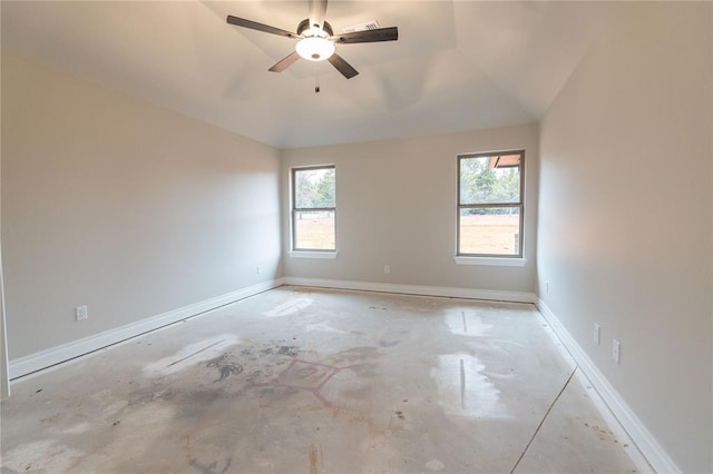 spare room featuring ceiling fan, plenty of natural light, and baseboards