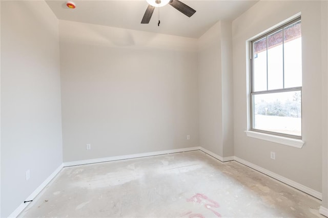 empty room featuring plenty of natural light, baseboards, and a ceiling fan