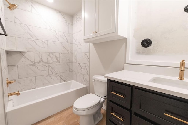 bathroom with tub / shower combination, vanity, toilet, and wood finished floors