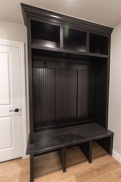 mudroom with wood tiled floor