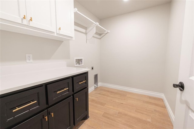 laundry area with washer hookup, light wood finished floors, cabinet space, hookup for an electric dryer, and baseboards