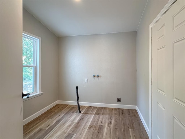 laundry room featuring hookup for an electric dryer, plenty of natural light, and light wood-type flooring