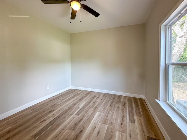 empty room with light hardwood / wood-style floors and ceiling fan