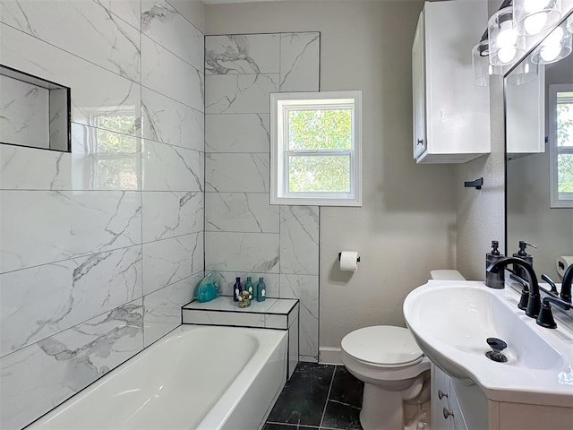 bathroom with a bathing tub, vanity, a healthy amount of sunlight, and toilet