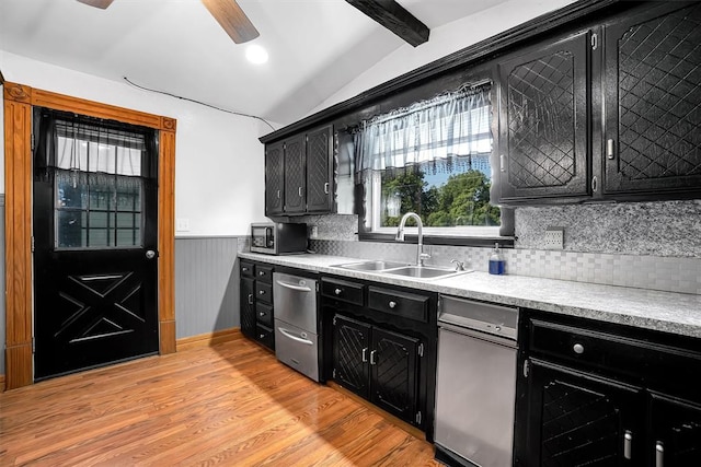 kitchen featuring sink, stainless steel appliances, tasteful backsplash, light hardwood / wood-style flooring, and lofted ceiling with beams