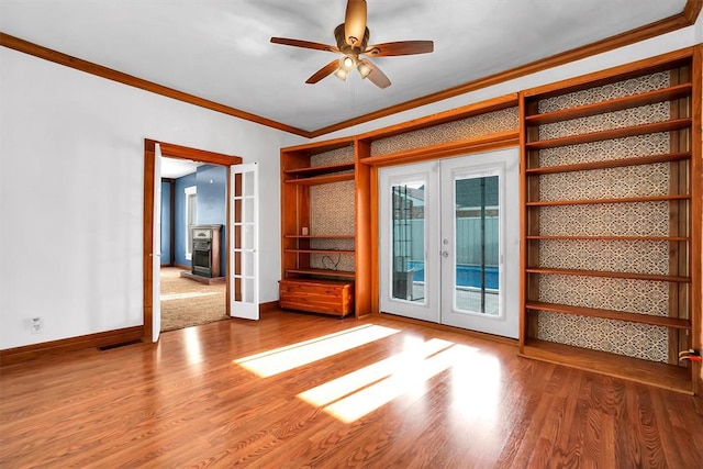 unfurnished room featuring french doors, hardwood / wood-style flooring, ceiling fan, and ornamental molding