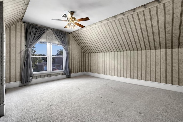 additional living space with ceiling fan, carpet floors, and vaulted ceiling