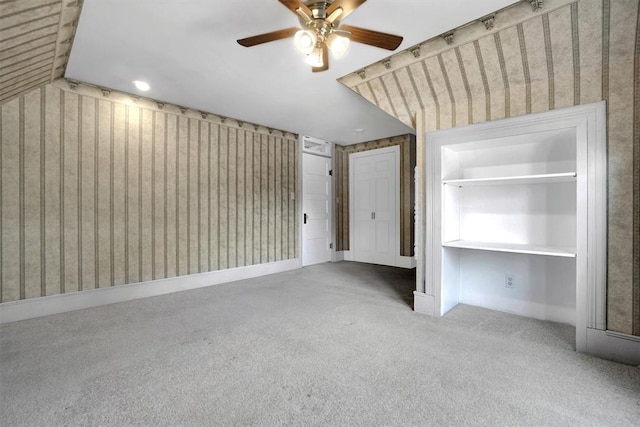 unfurnished bedroom featuring ceiling fan, lofted ceiling, and carpet floors