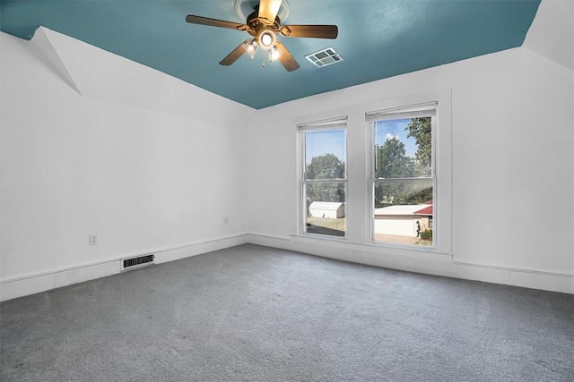 carpeted spare room with ceiling fan and lofted ceiling