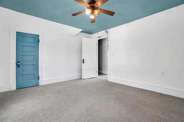 empty room with light colored carpet and ceiling fan