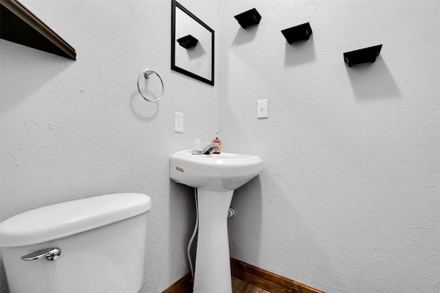 bathroom featuring hardwood / wood-style flooring and toilet