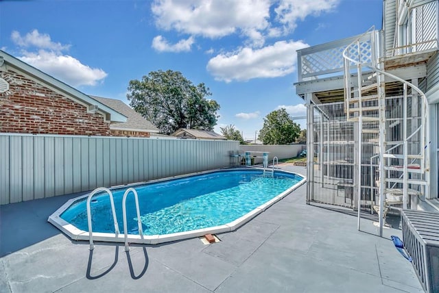 view of swimming pool with a patio