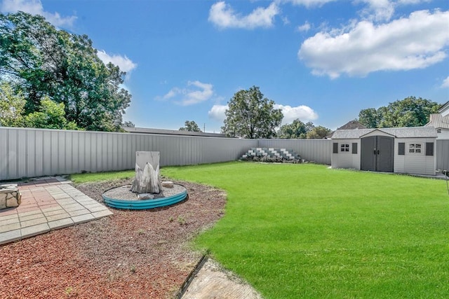 view of yard with a patio and a storage shed