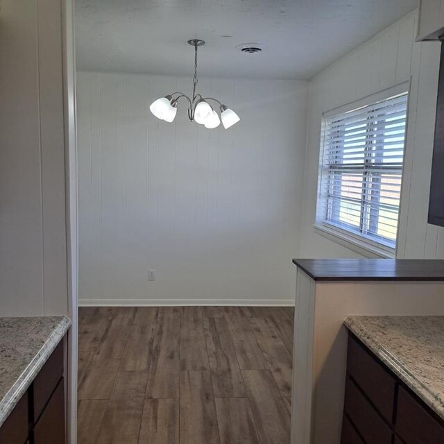 13401 N 2410th Rd, Mountain View, OK 73062 - unfurnished dining area with a chandelier and wood finished floors