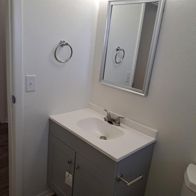 bathroom featuring vanity and toilet