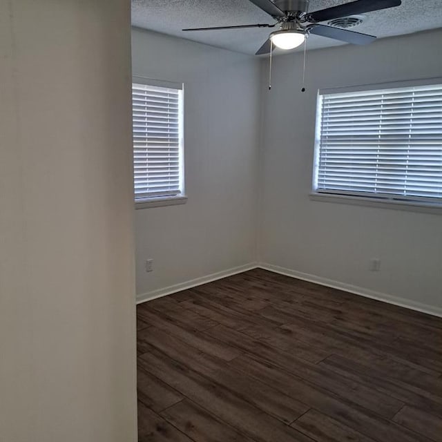 spare room featuring a textured ceiling, dark hardwood / wood-style flooring, and ceiling fan