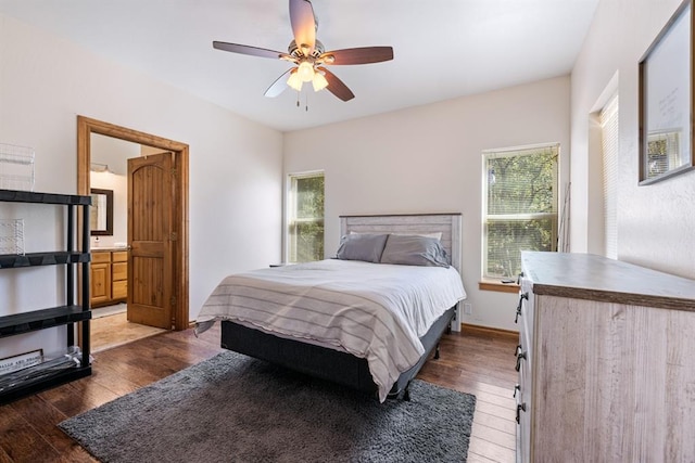 bedroom with dark hardwood / wood-style floors, ceiling fan, and multiple windows