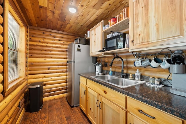 kitchen with sink, dark hardwood / wood-style floors, stainless steel fridge, rustic walls, and wood ceiling