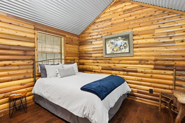 bedroom featuring dark hardwood / wood-style flooring, high vaulted ceiling, and rustic walls