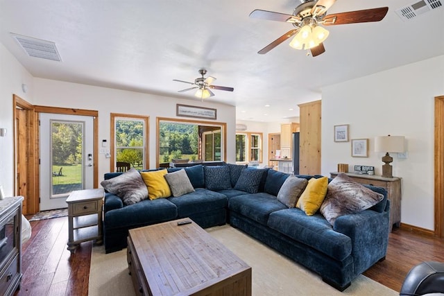 living room with hardwood / wood-style floors and ceiling fan