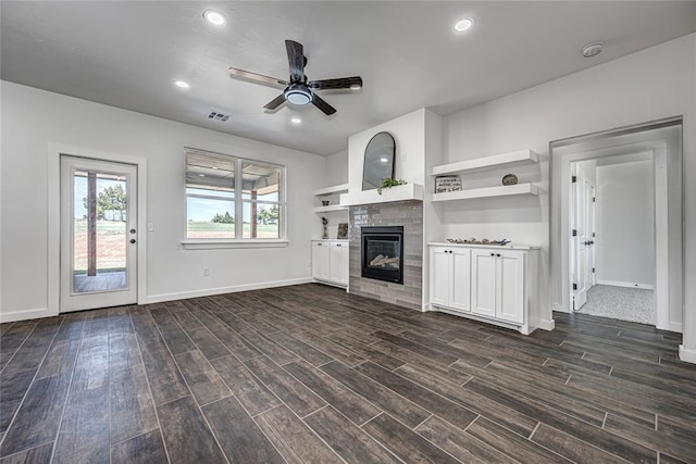 unfurnished living room featuring dark hardwood / wood-style flooring and ceiling fan