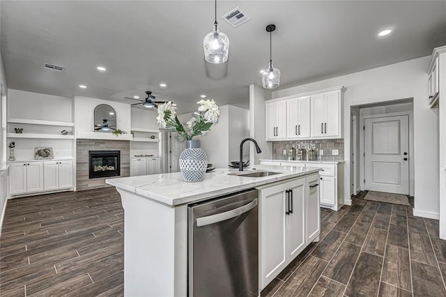 kitchen featuring dishwasher, white cabinetry, light stone countertops, and dark wood-type flooring