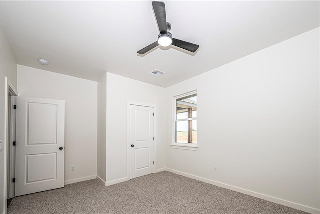 unfurnished bedroom featuring carpet, a closet, and ceiling fan