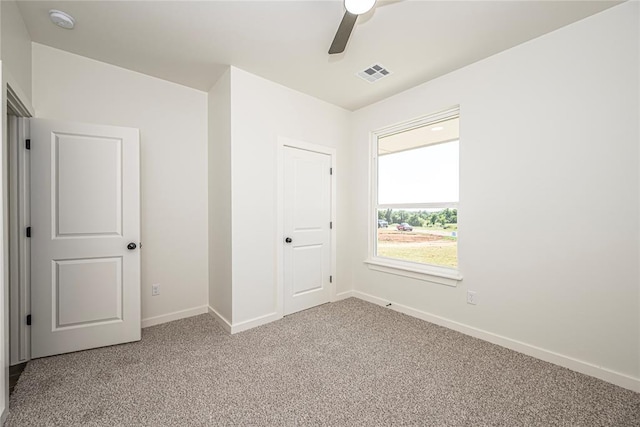 unfurnished bedroom featuring ceiling fan, a closet, and carpet