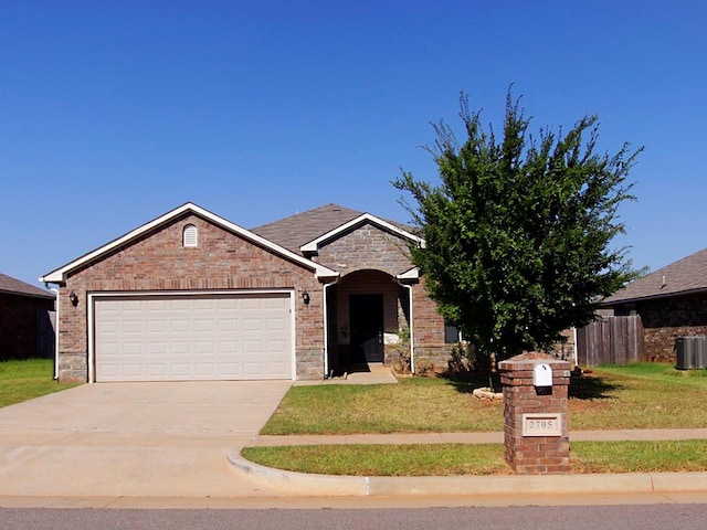 view of front of property with a front yard and a garage