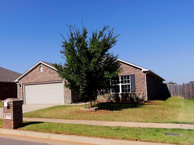 view of front of property featuring a front yard and a garage