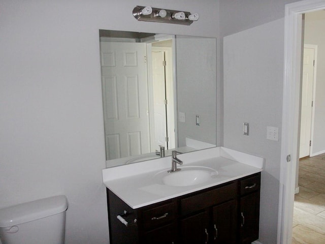 bathroom with tile patterned floors, vanity, and toilet