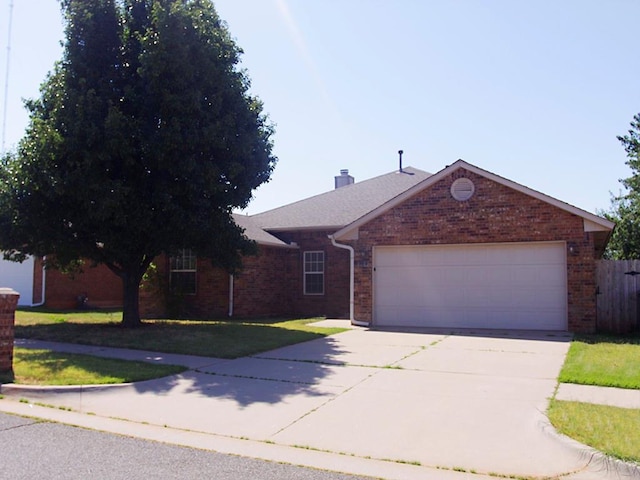 single story home with a front yard and a garage