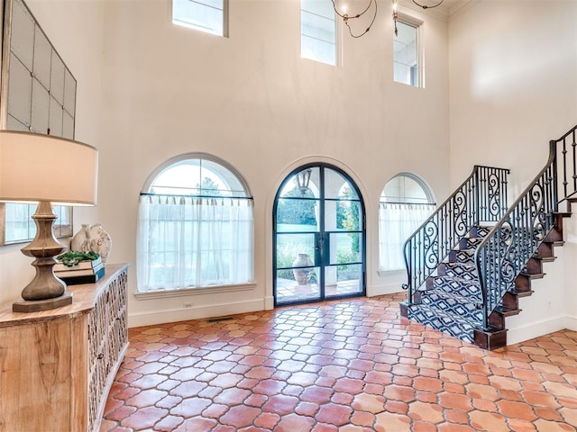 entrance foyer featuring a towering ceiling