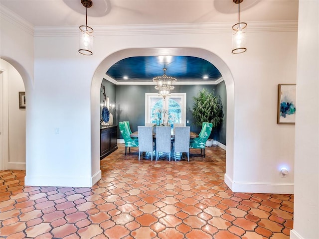 unfurnished dining area featuring crown molding and an inviting chandelier