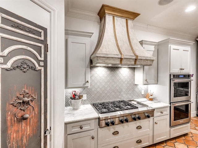 kitchen with appliances with stainless steel finishes, backsplash, premium range hood, and light stone counters