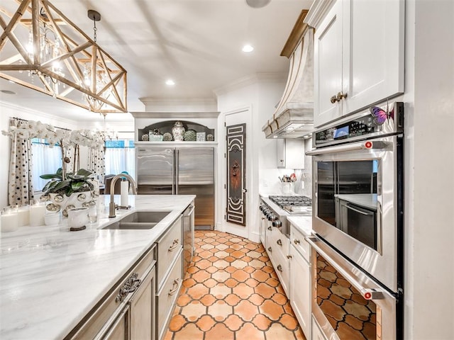 kitchen featuring white cabinetry, sink, ornamental molding, pendant lighting, and appliances with stainless steel finishes