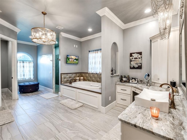 bathroom featuring a bath, vanity, ornamental molding, and a notable chandelier