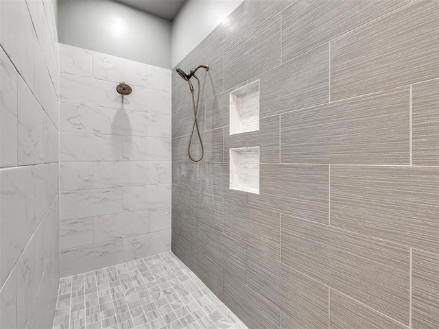 bathroom with a tile shower