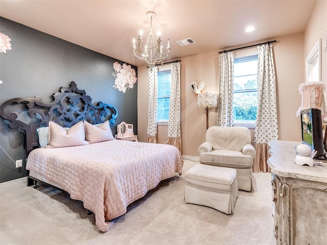 carpeted bedroom featuring a chandelier