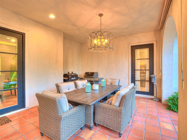 tiled dining area with an inviting chandelier