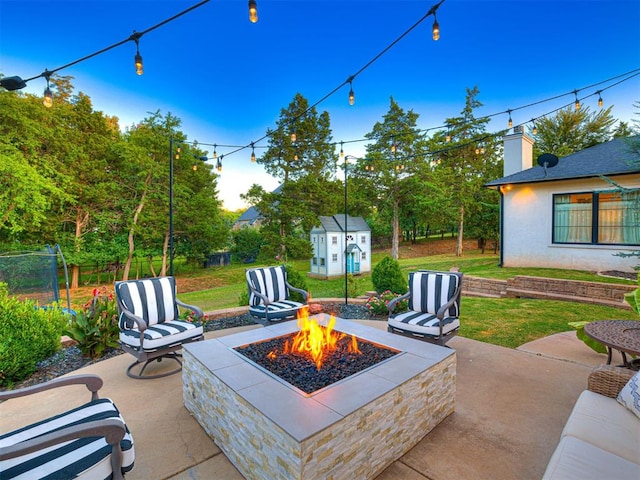 view of patio / terrace with a storage unit and an outdoor fire pit