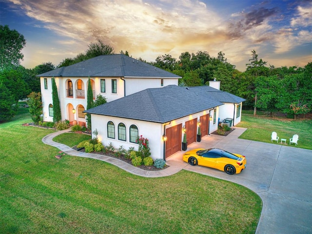 view of front facade with a lawn and a garage