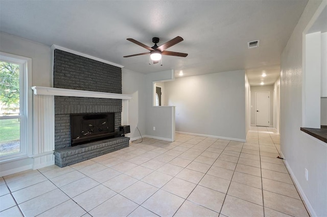 unfurnished living room with ceiling fan, light tile patterned flooring, and a brick fireplace