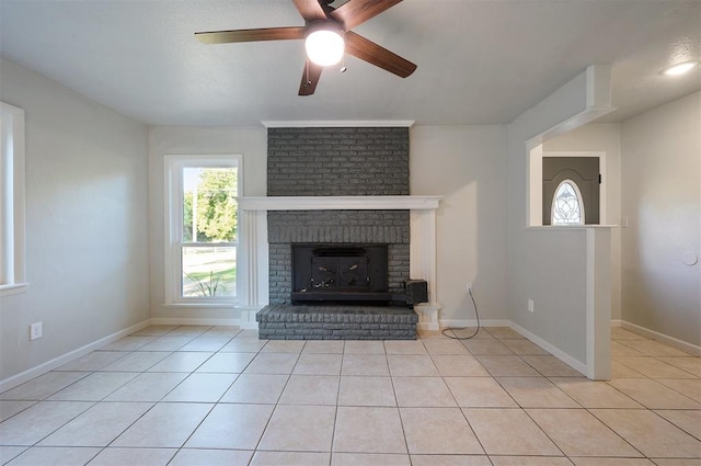 unfurnished living room featuring ceiling fan and light tile patterned floors