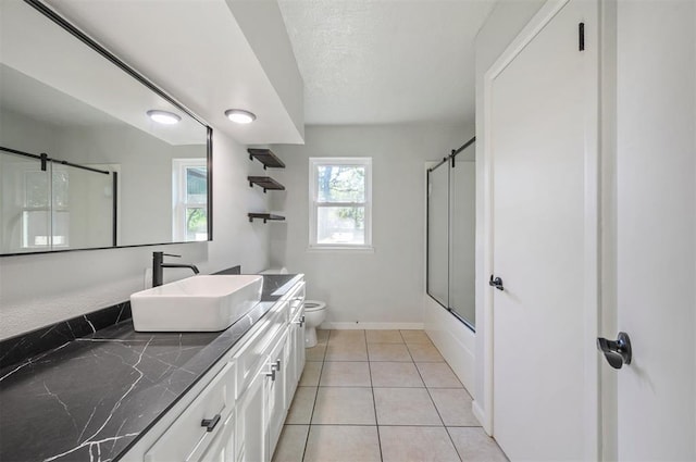 full bathroom with toilet, vanity, tile patterned floors, and shower / bath combination with glass door