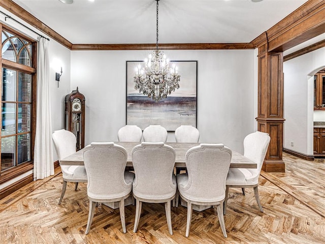 dining space with light parquet flooring, an inviting chandelier, and ornamental molding