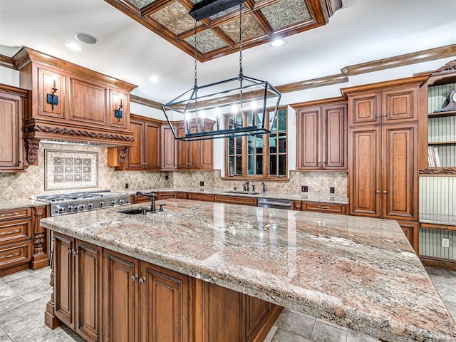 kitchen with light stone countertops, custom range hood, crown molding, and sink