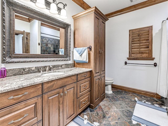 bathroom featuring vanity, toilet, and ornamental molding